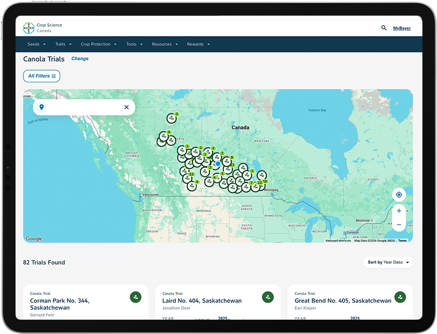 A laptop and mobile phone show a map overview with crop icons users can click on to view seed trials.